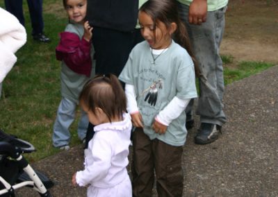 Three young children standing together at the Run to the Rogue event