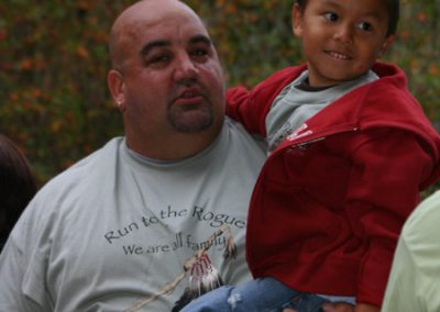 A man holding a younger boy during the Run to the Rogue event