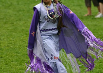 Fancy shawl dancer in purple regalia.